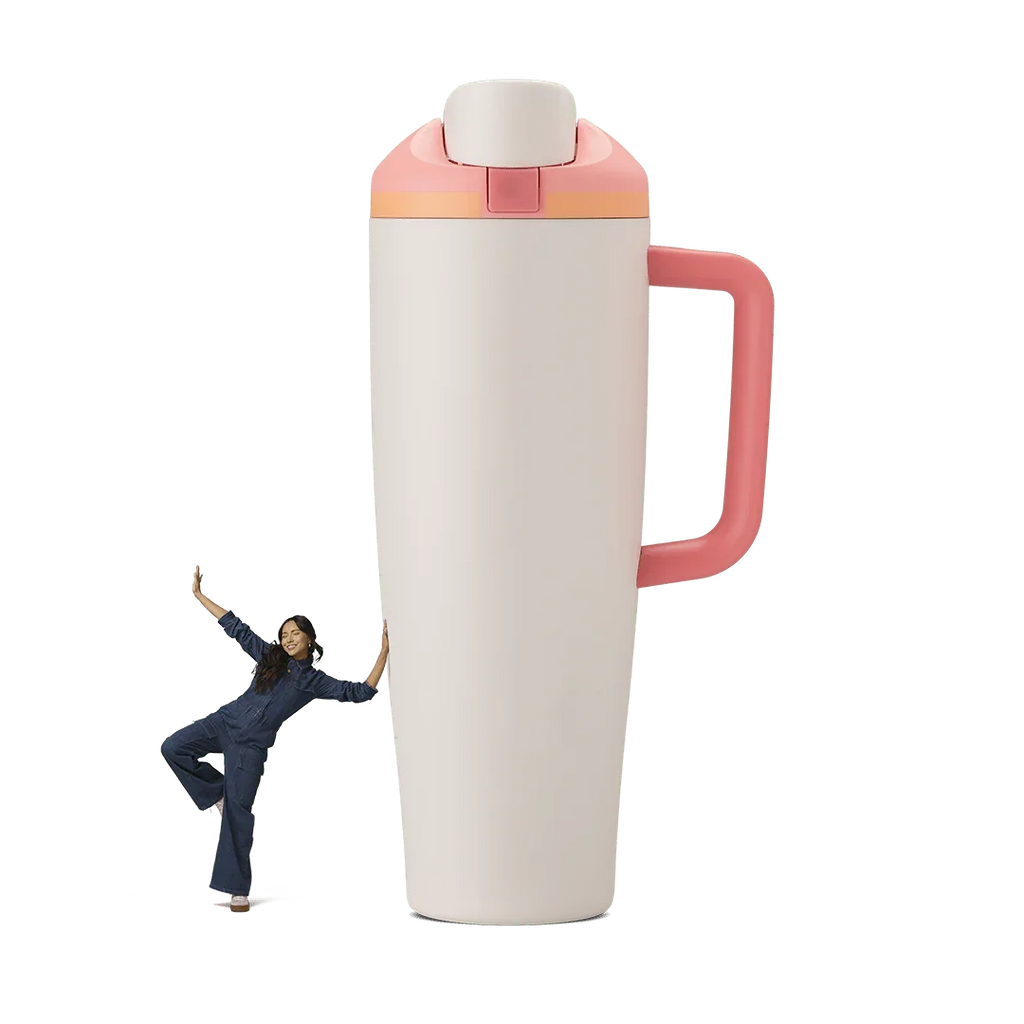 Large white and pink 40oz sparkling sherbet Miami tumbler with handle, woman in blue denim leaning on it