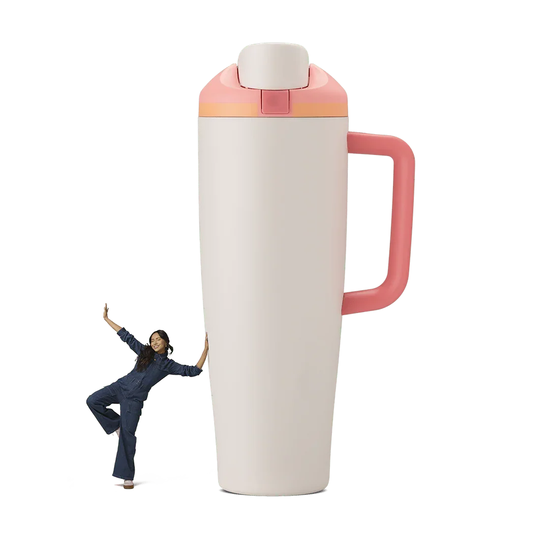 Large white and pink 40oz sparkling sherbet Miami tumbler with handle, woman in blue denim leaning on it