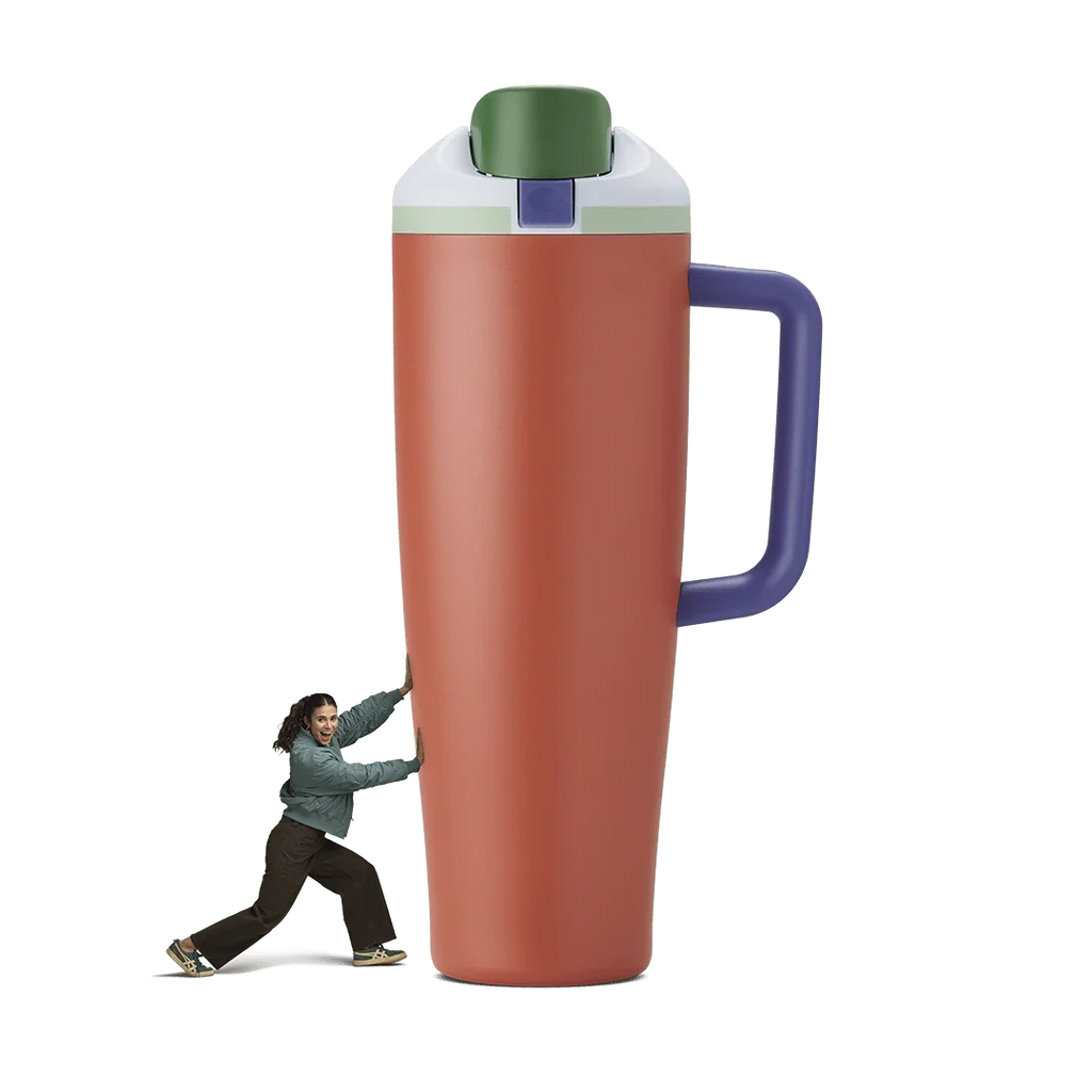 Orange 40oz Summer Harvest Miami tumbler with green lid and purple handle beside woman pushing it