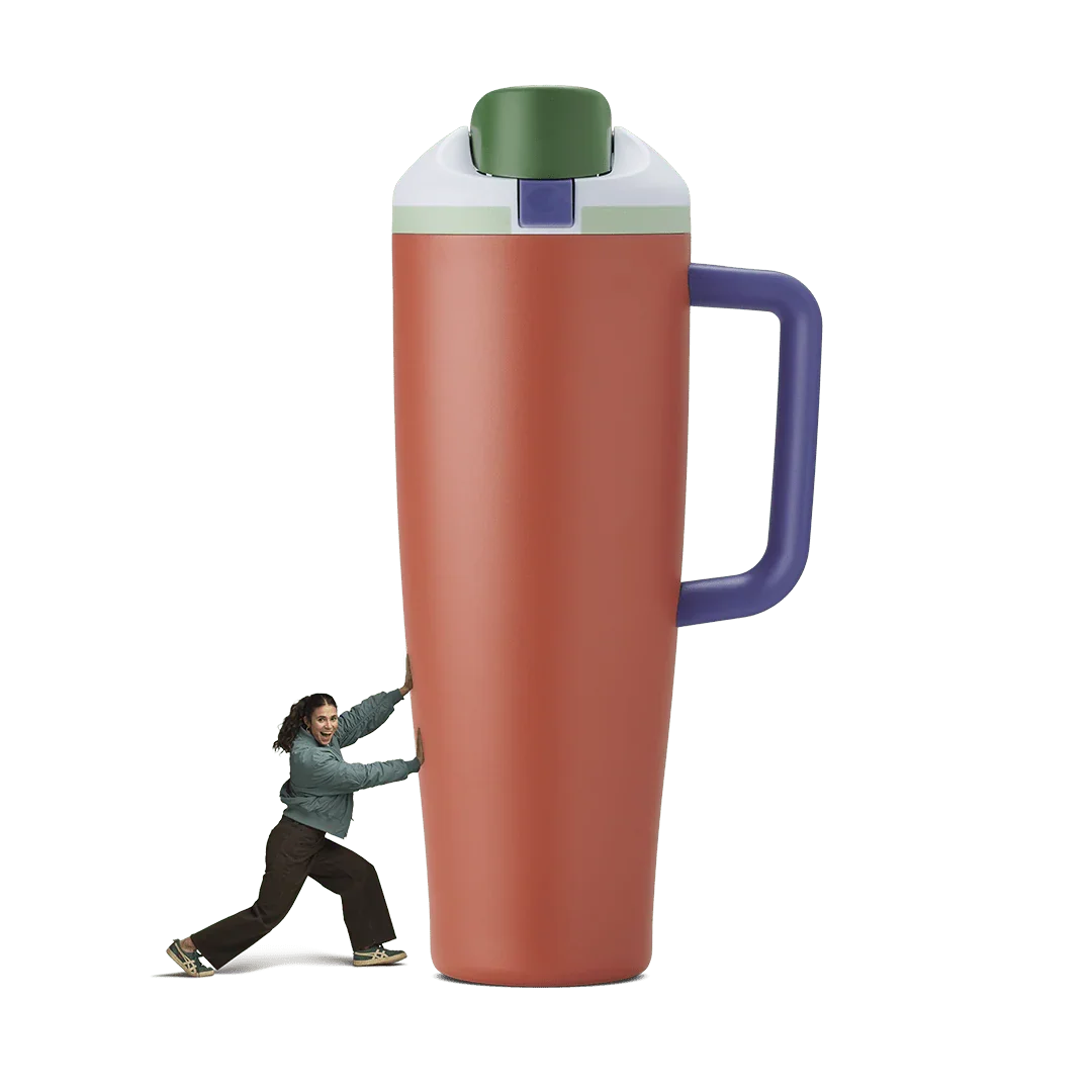 Orange 40oz Summer Harvest Miami tumbler with green lid and purple handle beside woman pushing it