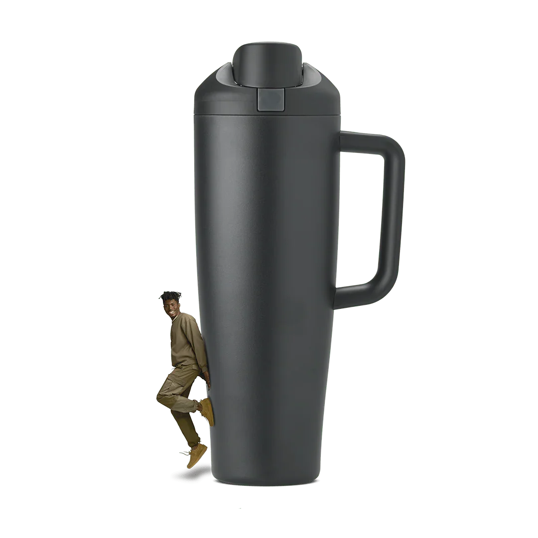 Tall black 40oz Miami tumbler with handle and flip lid, shown with a smiling man beside it