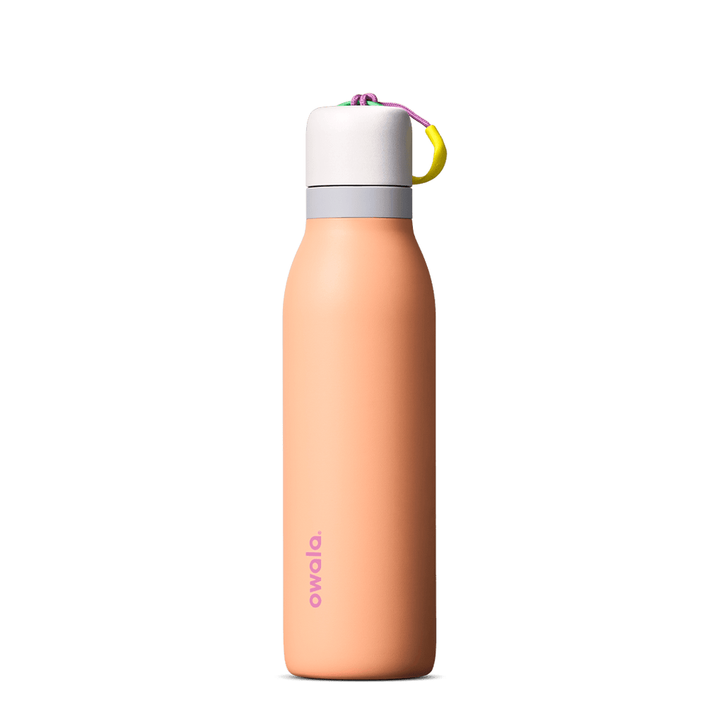 Peach-colored 18oz Owala water bottle with white lid and multicolor strap on white background