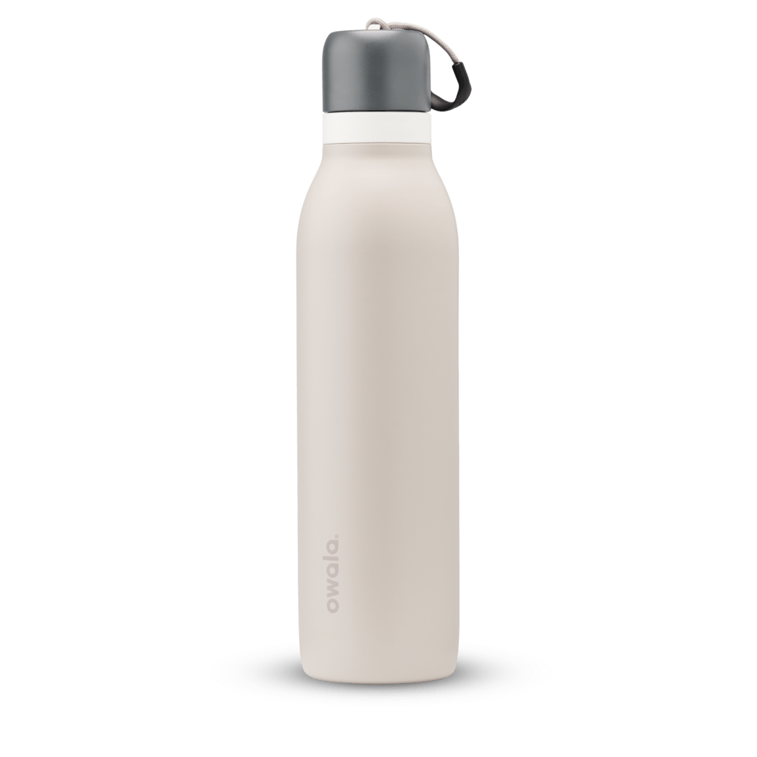 Owala 24oz beige insulated water bottle with gray cap and carrying loop