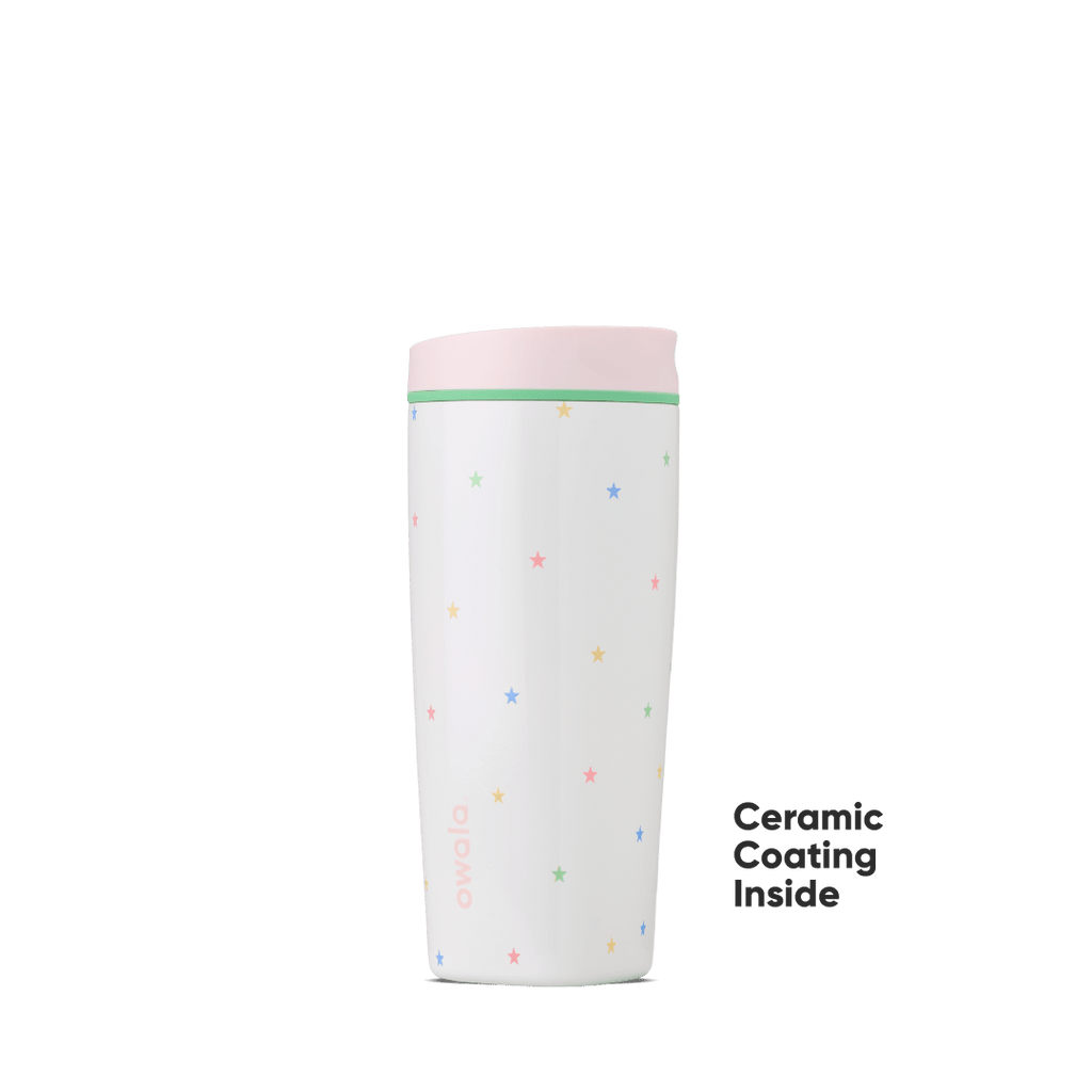 White Owala travel tumbler with colorful star pattern and pink lid featuring ceramic coating